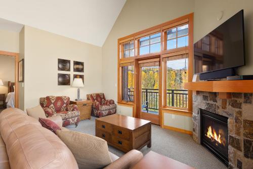 a living room with a couch and a fireplace at Pinecone Perch Capitol Peak Lodge #3227 in Snowmass Village