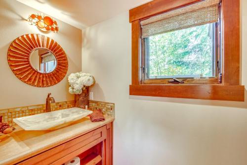 a bathroom with a sink and a mirror and a window at Golf Getaway with Hot Tub, Course Views in Cle Elum! in Cle Elum