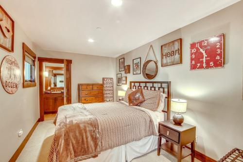 a bedroom with a bed and a table with a lamp at Golf Getaway with Hot Tub, Course Views in Cle Elum! in Cle Elum