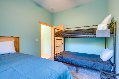 a bedroom with two bunk beds and a doorway at 5 Mi to Twin Lakes State Park Renovated Church! in Toivola