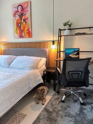 a bedroom with a bed and a desk with a television at 2-Bedroom Condo in Antipolo with Nature or Farm View in Antipolo