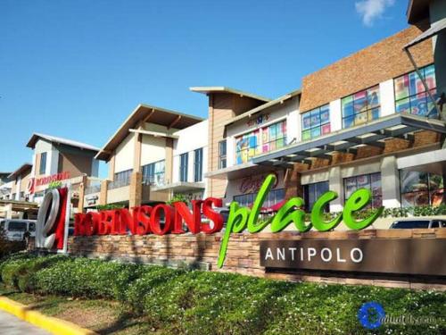 a building with a sign that reads queens palace antico at 2-Bedroom Condo in Antipolo with Nature or Farm View in Antipolo