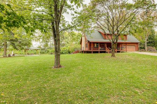 a log cabin with a gazebo and two trees at On-Site Lake and Gazebo Cabin in Yellow Springs! in Fairborn