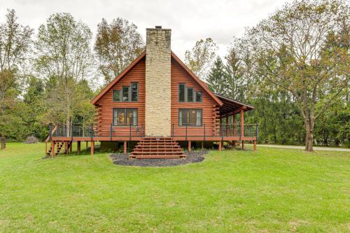 a log cabin with a porch and a chimney at On-Site Lake and Gazebo Cabin in Yellow Springs! in Fairborn