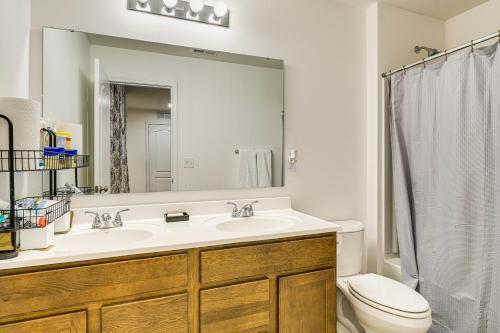 a bathroom with a sink and a toilet and a mirror at 16 Mi to Louisville Pet-Friendly Getaway! in Shepherdsville