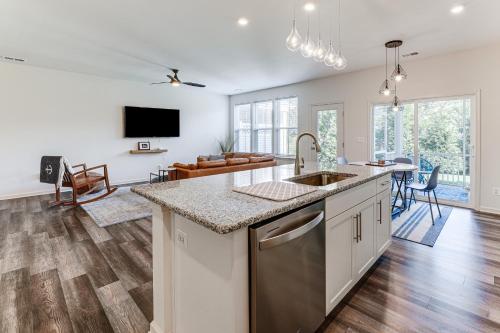 a kitchen with a sink and a living room at 5 Mi to Bethany Beach Resort-Style Gem with Pools! in Ocean View