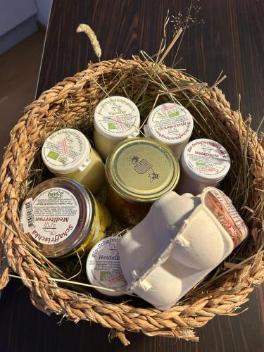 a basket of jam and cheese on a table at Stadtbauernhof Salzburg - Ferienwohnung - Gut Unterleithen - farm & the city in Salzburg