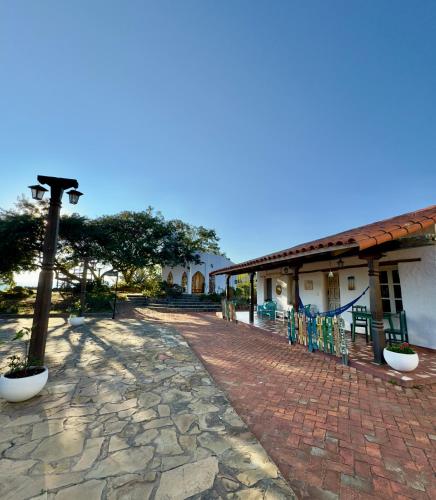 a brick walkway in front of a building at El Pueblito Hotel Boutique in Samaipata