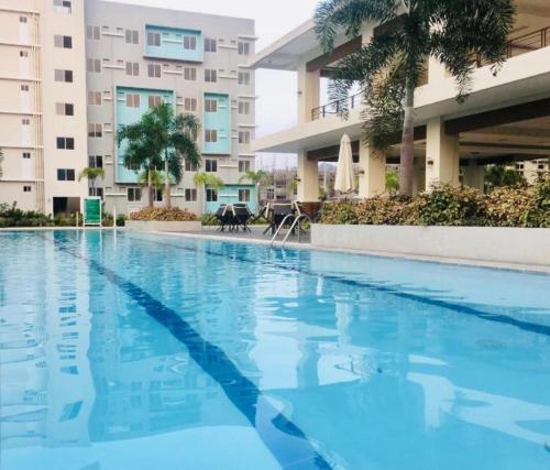 a swimming pool in front of a building at 2bdr condo rental furnished, w parking wifi free use pool in Davao City