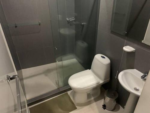 a bathroom with a shower and a toilet and a sink at Apartamento en ciudad jardín #7 in Cali