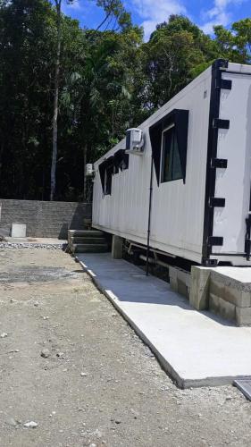 a white trailer with a door and a window at Tiny House completa proximo a Arena OPUS in São José