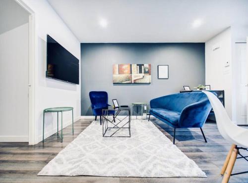 a living room with a blue couch and chairs at Charming 2 BD condo griffintown in Montréal