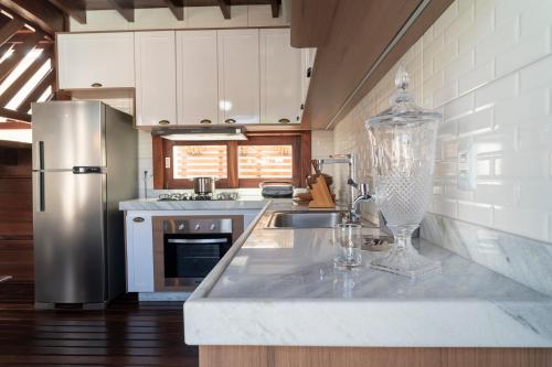 a kitchen with a sink and a refrigerator at Villa do Ze in Jijoca de Jericoacoara