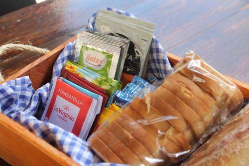 a picnic basket with a sandwich and other snacks at La Divina Pereza Eco in San Rafael