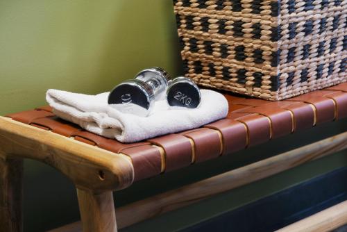 a wooden table with towels and a basket on it at Campanile Metz Nord - Talange in Talange