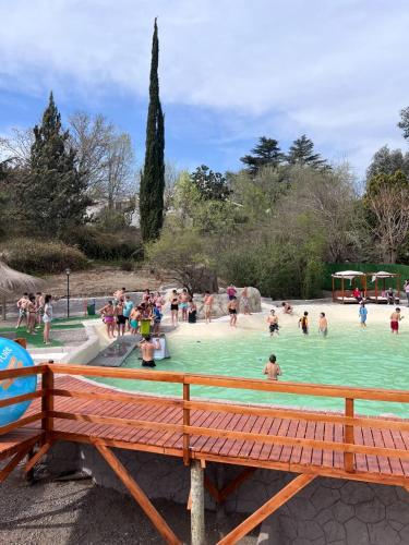 a group of people playing in a swimming pool at Hotel Terrazas by CPH in Villa Carlos Paz