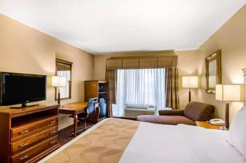 a hotel room with a bed and a flat screen tv at Precious Hotel in Carthage