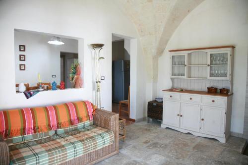 a living room with a couch and a cabinet at Il Casolare Degli Ulivi in Oria