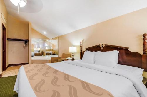 a hotel room with a large bed and a bathroom at Precious Hotel in Carthage