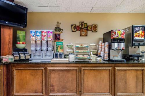 a counter in a restaurant with a coffee shop at Precious Hotel in Carthage
