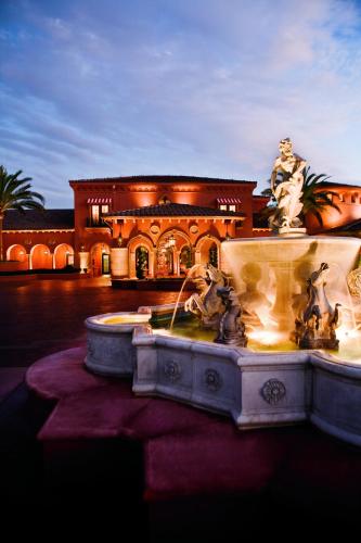 a fountain in front of a house with a building at Fairmont Grand Del Mar in San Diego