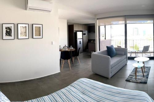 a living room with a couch and a chair at Amazing Loft Plaza Mayor Zone AC Wifi CoWorking in Miravalle