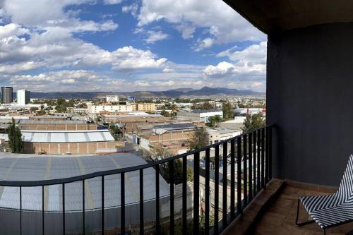a balcony with a view of a city at Amazing Loft Plaza Mayor Zone AC Wifi CoWorking in Miravalle