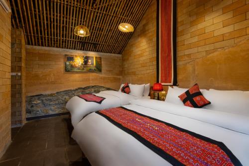 a room with two beds in a room at Sapaxa Spring Garden Ecolodge in Sa Pa