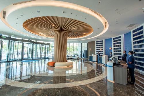 a lobby of a building with a large ceiling at Holiday Inn Express Yinchuan Lanxi Valley Plaza by IHG in Yinchuan