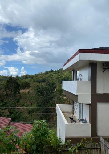 a balcony of a building with a hill in the background at Vela Terraces Hotel in Coron