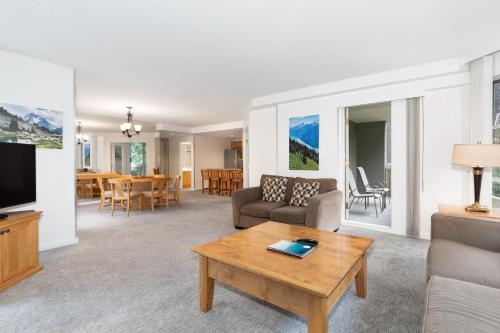 a living room with a couch and a coffee table at The Woodrun Lodge by Whiski Jack in Whistler