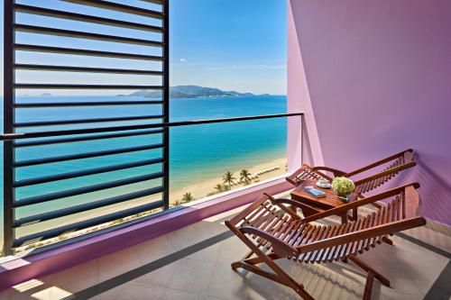 a balcony with two benches and a view of the beach at Novotel Nha Trang in Nha Trang