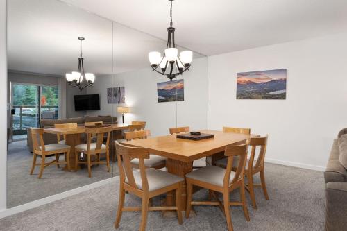 a dining room with a table and chairs at The Woodrun Lodge by Whiski Jack in Whistler