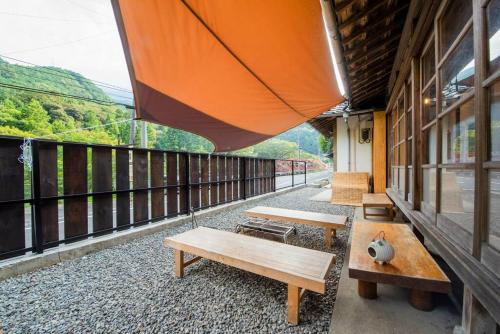 a balcony with benches on the side of a building at 自然と遊ぶ古民家宿 石鎚別荘ハレとあお in Komatsu