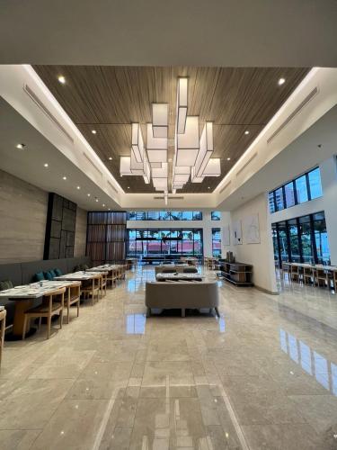 a large room with tables and chairs and a chandelier at Courtyard by Marriott Melaka in Melaka