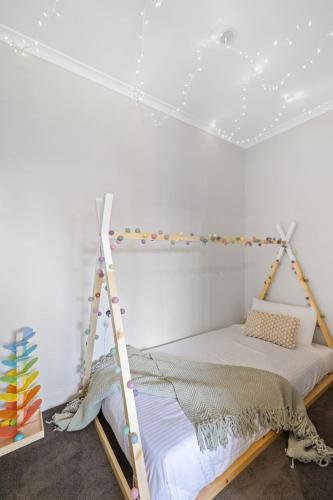 a bed with a ladder in a room at BIG4 Ingenia Holidays Inverloch in Inverloch