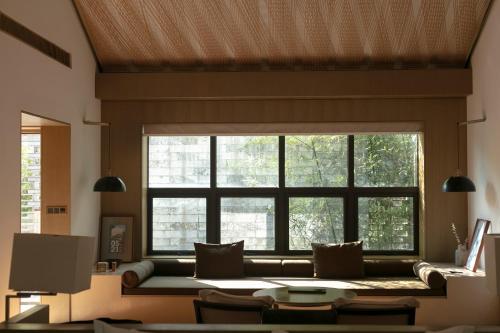 a living room with a couch and a large window at Yangshuo Sugar House in Yangshuo