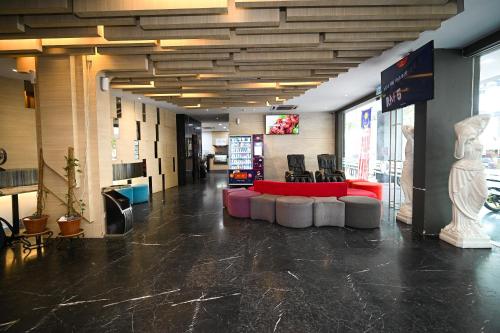 a lobby of a store with a red table and chairs at Kingston Hotel 2 - Setapak in Kuala Lumpur
