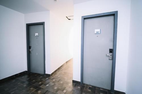 two doors in a room with a hallway at Kingston Hotel 2 - Setapak in Kuala Lumpur