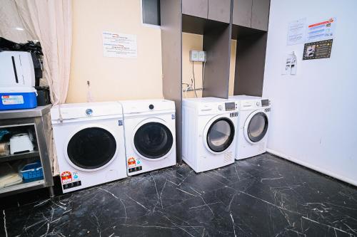 two washing machines and a washer and dryer in a room at Kingston Hotel 2 - Setapak in Kuala Lumpur