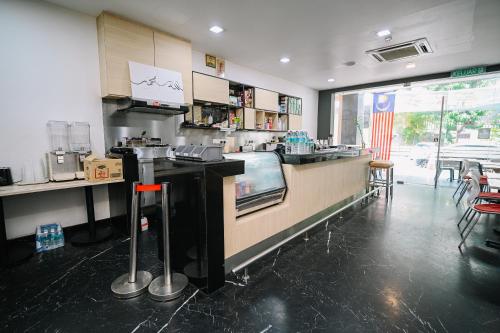 a kitchen with a counter in a restaurant at Kingston Hotel 2 - Setapak in Kuala Lumpur