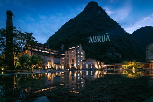a building in front of a mountain at night at Yangshuo Sugar House in Yangshuo