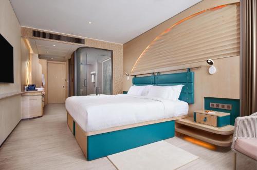 a bedroom with a large bed and a tv at WM Hotel Hong Kong, Vignette Collection in Hong Kong