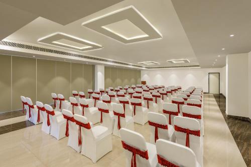 a conference room with white and red chairs at Ginger Vishakhapatnam Gajuwaka in Visakhapatnam