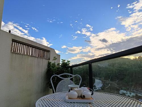 a table with a tea set on a balcony at 372 Jingjing's Home Inn in Yongshun