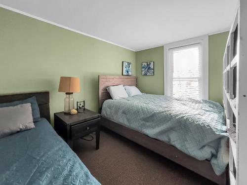 a bedroom with two beds and a window at The Kelly House - 4 BR Historic Lodge - Downtown in Ellicottville