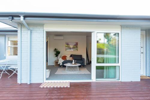 a sliding glass door on a house with a patio at Restful Retreat in Tauranga