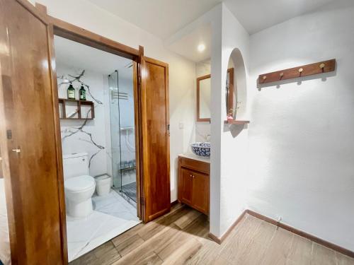 a bathroom with a toilet and a glass shower at Bian Cheng Xing Zi Inn in Fenghuang County