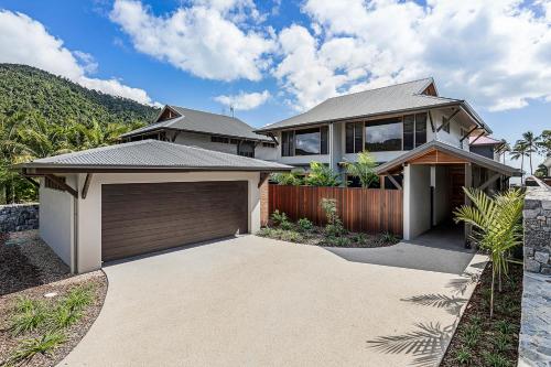 a house with a garage in front of it at Yangaro in Airlie Beach