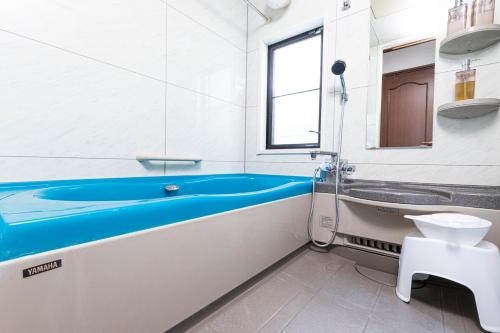a bathroom with a tub and a sink at IROHA STAY HANEDA - Family-Friendly Home Stay near Haneda with Great Access to Tokyo & Yokohama in Tokyo